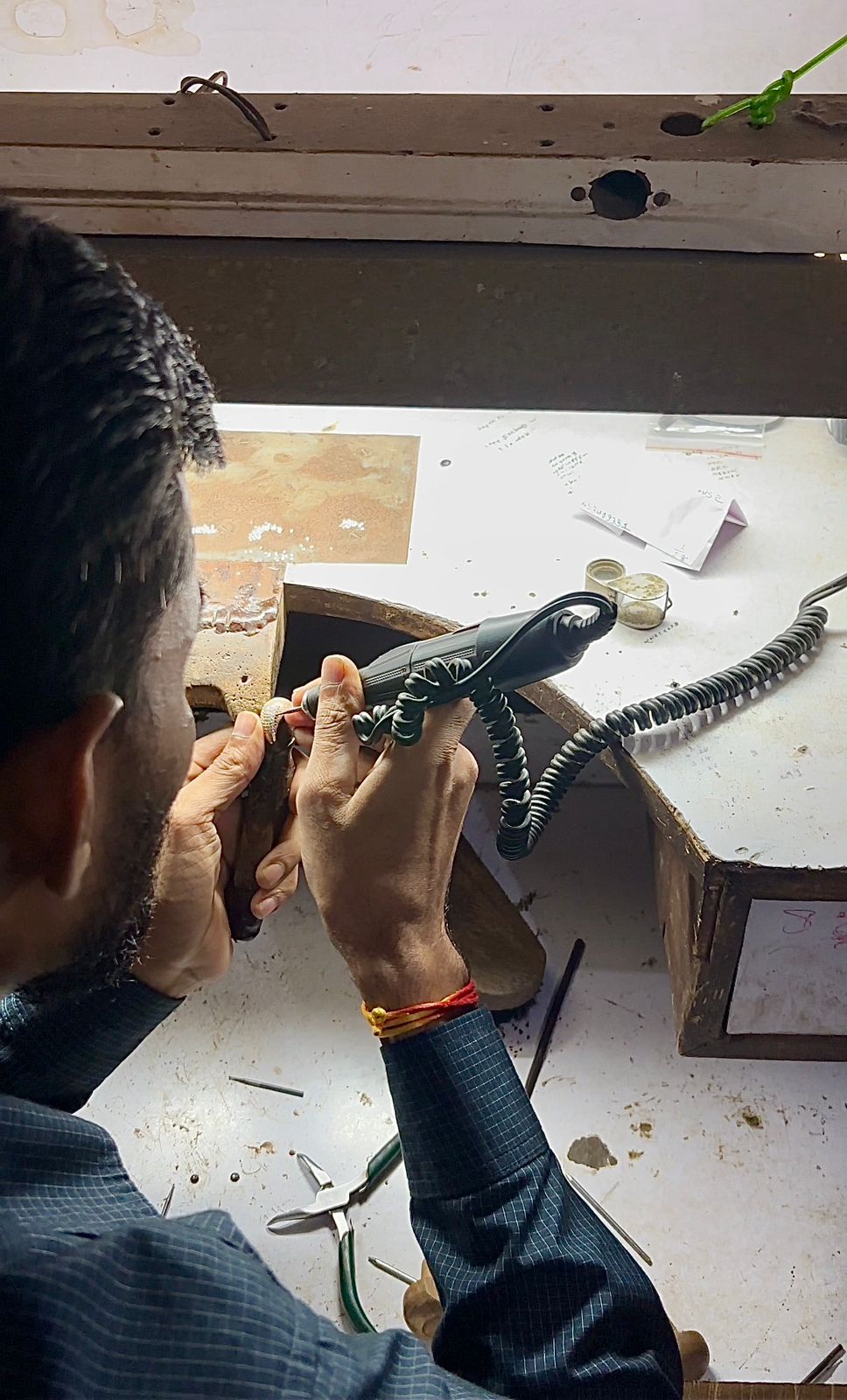 Artisan crafting jewelry with precision and attention to detail